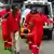 Kenya Red Cross members carry an injured mourner in a stretcher from Prime Minister Raila Odinga memorial service at the Jomo Kenyatta Stadium on October 18, 2025