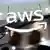 People walk past the logo of Amazon Web Services (AWS) at its exhibitor stall at the India Mobile Congress on October 8, 2025