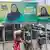 People walk past electoral campaign billboards of Tanzania's President Samia Suluhu Hassan of the ruling Chama Cha Mapinduzi Party (CCM) ahead of the general elections in Ilala district of Dar es Salaam, Tanzania October 28, 2025