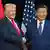 US President Donald Trump (L) and China's President Xi Jinping shake hands as they arrive for talks at the Gimhae Air Base, located next to the Gimhae International Airport in Busan, South Korea