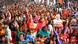 A crowd of people wearing bright colors at a political rally in Bihar, India A crowd of people wearing bright colors at a political rally in Bihar, India