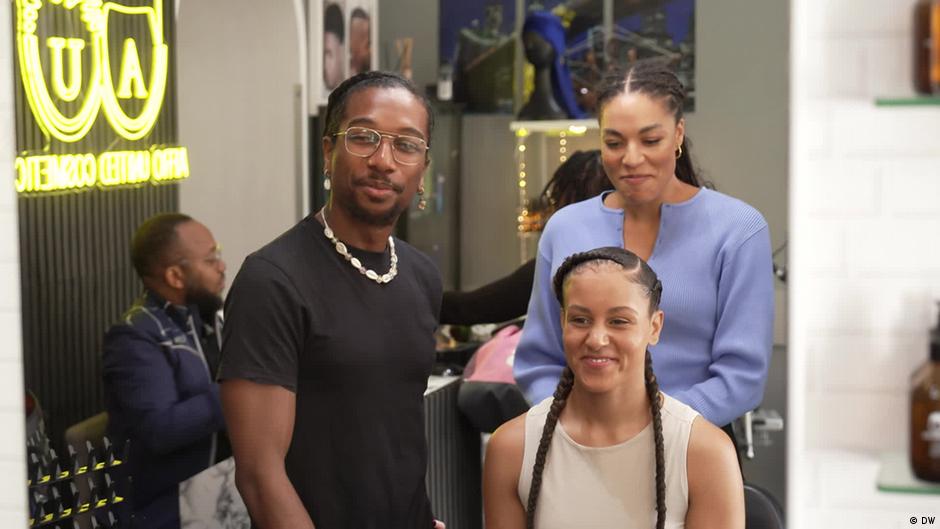 Hands braiding hair with extensions