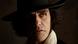 Film still: Oscar Isaac as Victor Frankenstein, close-up portrait of a man wearing a hat.