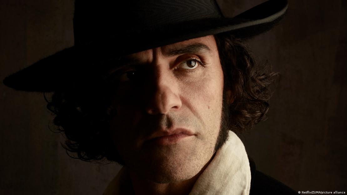 Film still: Oscar Isaac as Victor Frankenstein, close-up portrait of a man wearing a hat.