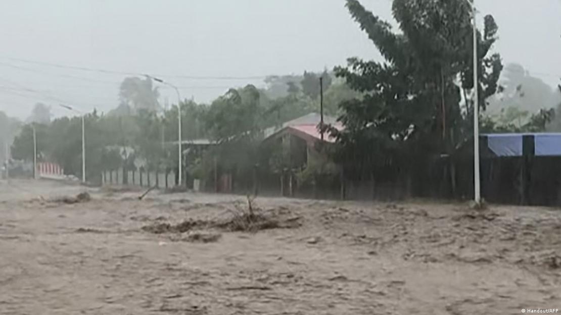 Water raging along a road Water raging along a road