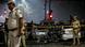 Delhi police stand around blown up cars Delhi police stand around blown up cars