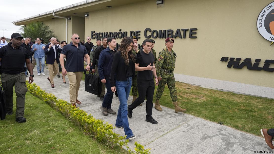 A group of people walk along the outside of an airforce base. A group of people walk along the outside of an airforce base.