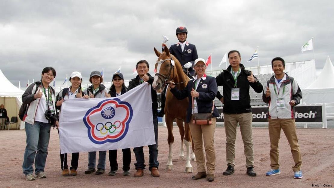 The photo shows Lin Wu-Tien and the Taiwan team at the 2014 World Equestrian Games in Caen, France.