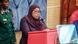 Tanzania's President Samia Suluhu Hassan addresses parliament as a soldier stands behind her Tanzania's President Samia Suluhu Hassan addresses parliament as a soldier stands behind her