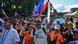Protesters wave flags and shout slogans during an anti-corruption rally in Quezon City, Metro Manila on November 16, 2025 Protesters wave flags and shout slogans during an anti-corruption rally in Quezon City, Metro Manila on November 16, 2025