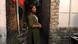 A young Indian woman stands in front of a narrow alley (November 20, 2024) A young Indian woman stands in front of a narrow alley (November 20, 2024)