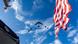 View into the sky showing US fighter jets and a portion of the US flag View into the sky showing US fighter jets and a portion of the US flag