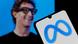 The Meta logo displayed on a cellphone with an image of CEO Mark Zuckerberg wearing AI glasses behind The Meta logo displayed on a cellphone with an image of CEO Mark Zuckerberg wearing AI glasses behind