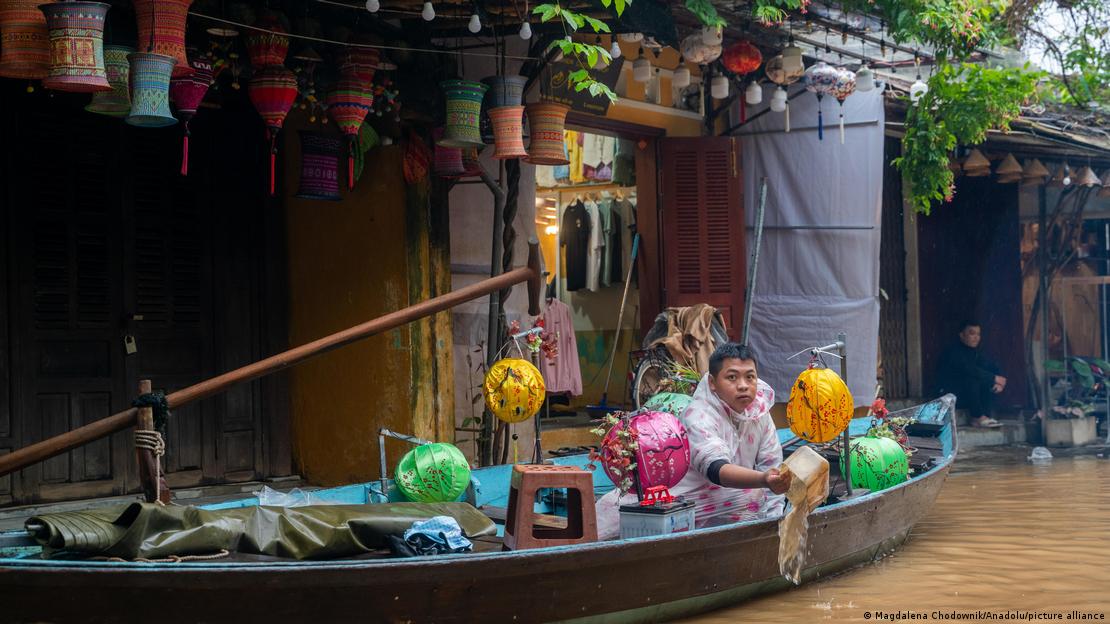 Un habitante de Hoi An, Vietnam, en un bote, en medio del agua que rodea varias viviendas. (19.11.20259.