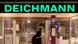 Bir Deichmann mağazası ve önünden yürüyen bir kişi Bir Deichmann mağazası ve önünden yürüyen bir kişi