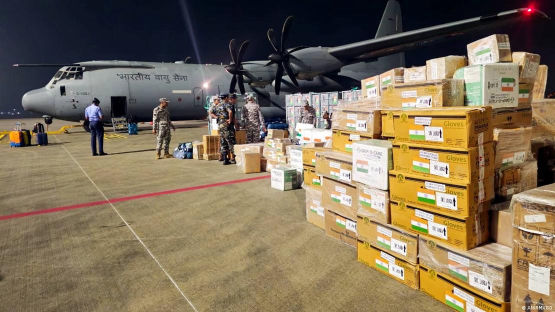 An Indian military cargo plane parked at the Colombo airport in Sri Lanka with boxes of aid stacked up nearby