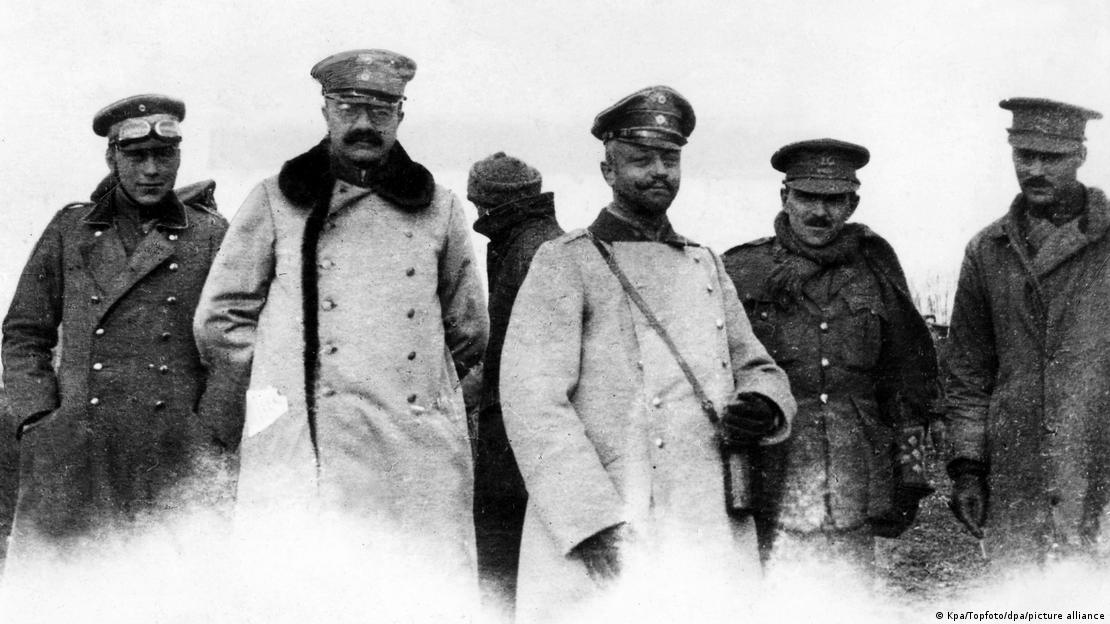 Black and white photo of German and British officers standing side by side