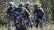 German army recruits dressed in fatigues carrying weapons, walking through a wooded area, in a training exercise German army recruits dressed in fatigues carrying weapons, walking through a wooded area, in a training exercise