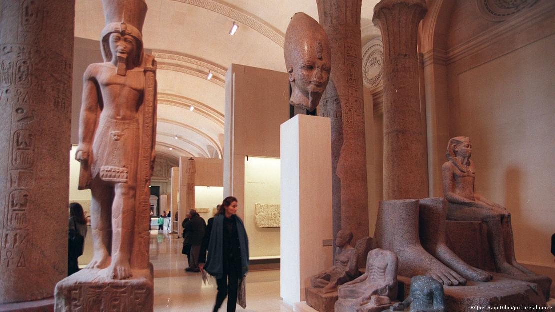 Visitors walk through the Egyptian galleries at the Louvre Museum in Paris