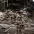 A Ukrainian police officer checks an area for residents amid the wreckage of the frontline town of Dobropillia