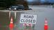 A driver manages to drive through flood waters from the Snohomish River in Snohomish, Washington A driver manages to drive through flood waters from the Snohomish River in Snohomish, Washington