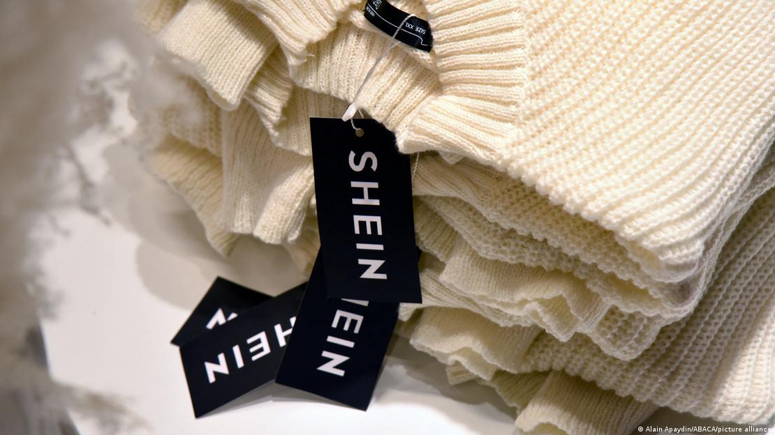 Pilha de pulôveres cor creme com etiqueta da Shein