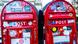 Two Danish red letterboxes stand side by side, covered in stickers Two Danish red letterboxes stand side by side, covered in stickers