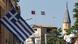 In the foreground, a Greek national flag projects out from the façade of a building. In the background, the flags of Turkey (center) and the self-declared Turkish Republic of Northern Cyprus (right) can be seen at a military outpost. Nicosia, Cyprus, July 9, 2024 In the foreground, a Greek national flag projects out from the façade of a building. In the background, the flags of Turkey (center) and the self-declared Turkish Republic of Northern Cyprus (right) can be seen at a military outpost. Nicosia, Cyprus, July 9, 2024