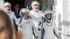 A crew of three men and one woman in space suits and helmets wave and smile as they head to the launch pad, July 2025 A crew of three men and one woman in space suits and helmets wave and smile as they head to the launch pad, July 2025