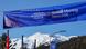 A banner with the logo of the World Economic Forum on it shown before a backdrop of snow-covered mountains in the Swiss Alps A banner with the logo of the World Economic Forum on it shown before a backdrop of snow-covered mountains in the Swiss Alps