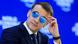 President Macron in Davos wearing reflective sunglasses against a blue backdrop President Macron in Davos wearing reflective sunglasses against a blue backdrop