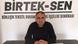 Mehmet Türkmen, BİRTEK-SEN logosu önündeki masada açıklama yaparken. Mehmet Türkmen, BİRTEK-SEN logosu önündeki masada açıklama yaparken.