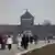 A view of the Main Gate as visitors are seen at the former Nazi German concentration camp Auschwitz.