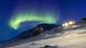 Aurora borealis lights up the sky above the houses of the Inuit village of Kapisillit Aurora borealis lights up the sky above the houses of the Inuit village of Kapisillit