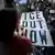 People look on from a skyway as demonstrators march during a "Nationwide Shutdown" demonstration against ICE enforcement on January 30, 2026 in Minneapolis, Minnesota