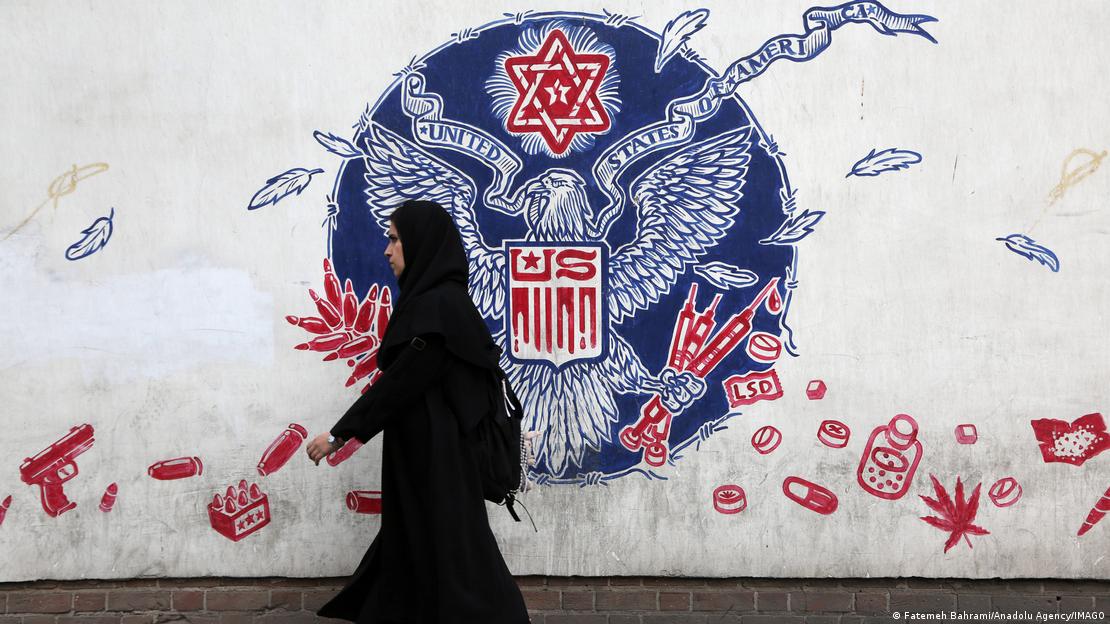 Një grua duke kaluar pranë një murali anti‑amerikan në Teheran pas ndërhyrjes së SHBA‑së kundër Iranit më 28 janar 2026
