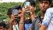 A group of young men taking photos and recording videos with their smartphone in Mumbai A group of young men taking photos and recording videos with their smartphone in Mumbai