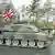 A British tank driving down a street