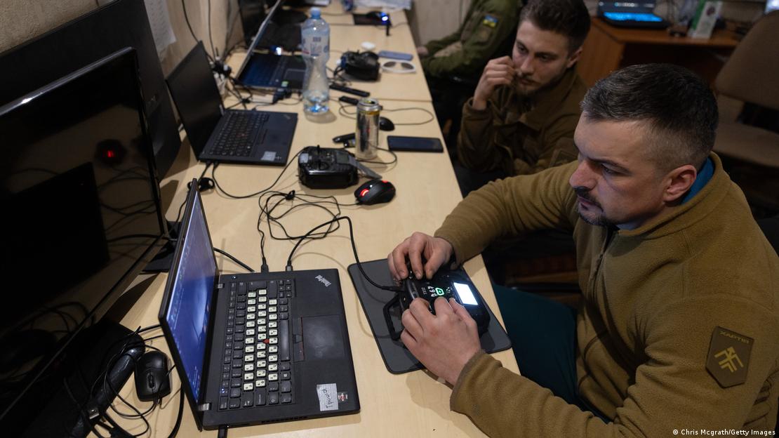 Soldados ucranianos operam drone com uso de controle remoto e laptops