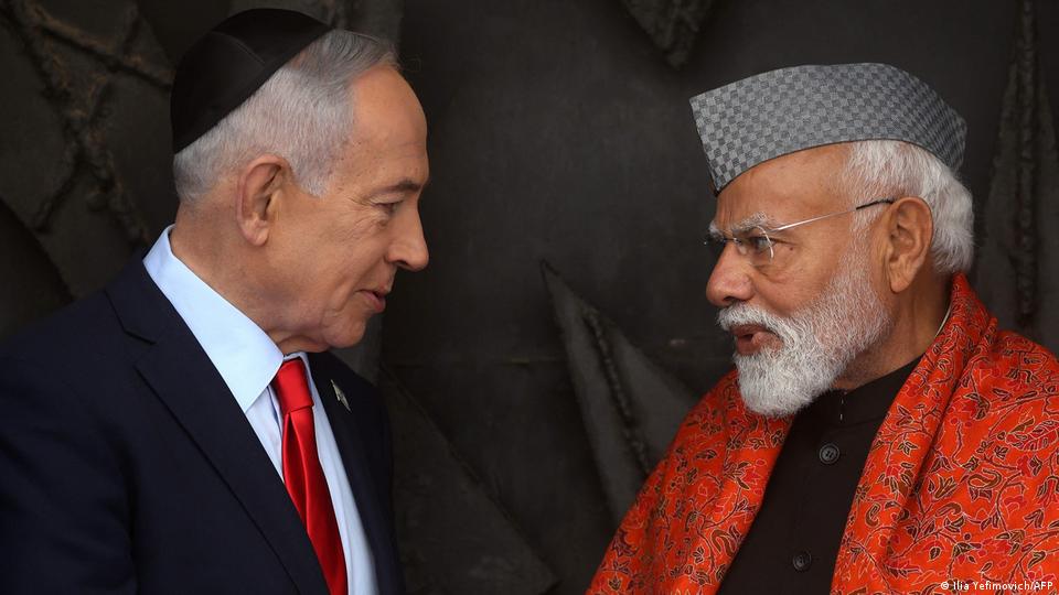 India's Prime Minister Narendra Modi (R) speaks with his Israeli counterpart Benjamin Netanyahu