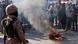 People set ablaze a tyre as a paramilitary soldier stands during a protest outside the US Consulate General in Karachi People set ablaze a tyre as a paramilitary soldier stands during a protest outside the US Consulate General in Karachi