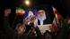 Iraqi Shiites shout slogans as they carry a portrait of Iran's Supreme Leader Ayatollah Ali Khamenei. Iraqi Shiites shout slogans as they carry a portrait of Iran's Supreme Leader Ayatollah Ali Khamenei.