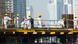 Migrant workers on construction site of high-rise apartment skyscraper tower in Dubai Migrant workers on construction site of high-rise apartment skyscraper tower in Dubai