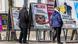 People in winter jackets look at posters calling for the partial defunding of Switzerland's public broadcast system People in winter jackets look at posters calling for the partial defunding of Switzerland's public broadcast system