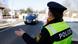 A police officer in Bavaria raises her hand to stop a car approaching a check-point A police officer in Bavaria raises her hand to stop a car approaching a check-point