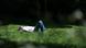 A man lies in the grass in a park in London, UK A man lies in the grass in a park in London, UK