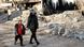 A mother and son walk near a building destroyed in a strike, amid the US-Israeli conflict with Iran, in Tehran, Iran, March 21, 2026 A mother and son walk near a building destroyed in a strike, amid the US-Israeli conflict with Iran, in Tehran, Iran, March 21, 2026