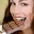 Woman eats bar of chocolate