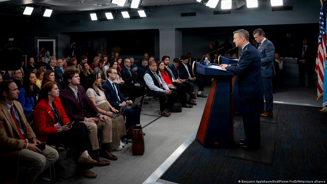 US Joint Chiefs of Staff Chair General Dan Caine responds to a reporters question as Secretary of Defense Pete Hegseth looks on during a press briefing to discuss Operation Epic Fury at the Pentagon
