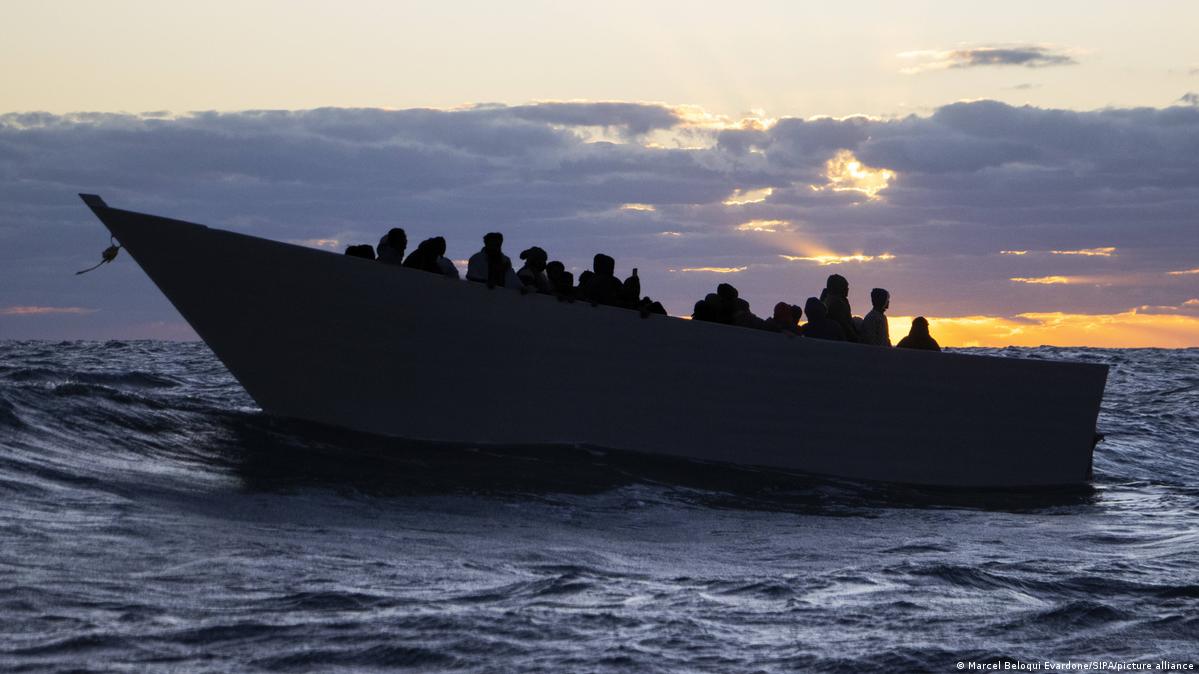 A boat carrying migrants sails at sea during a search-and-rescue operation in the Mediterranean Sea on November 24, 2025